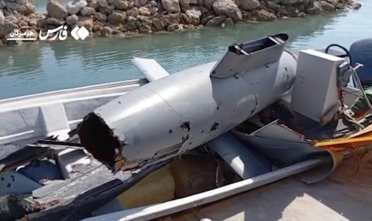 The wreckage of a drone is placed in a boat, at Hormuz Island