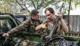 Ukrainian servicemen return from positions near the frontline in Kharkiv region