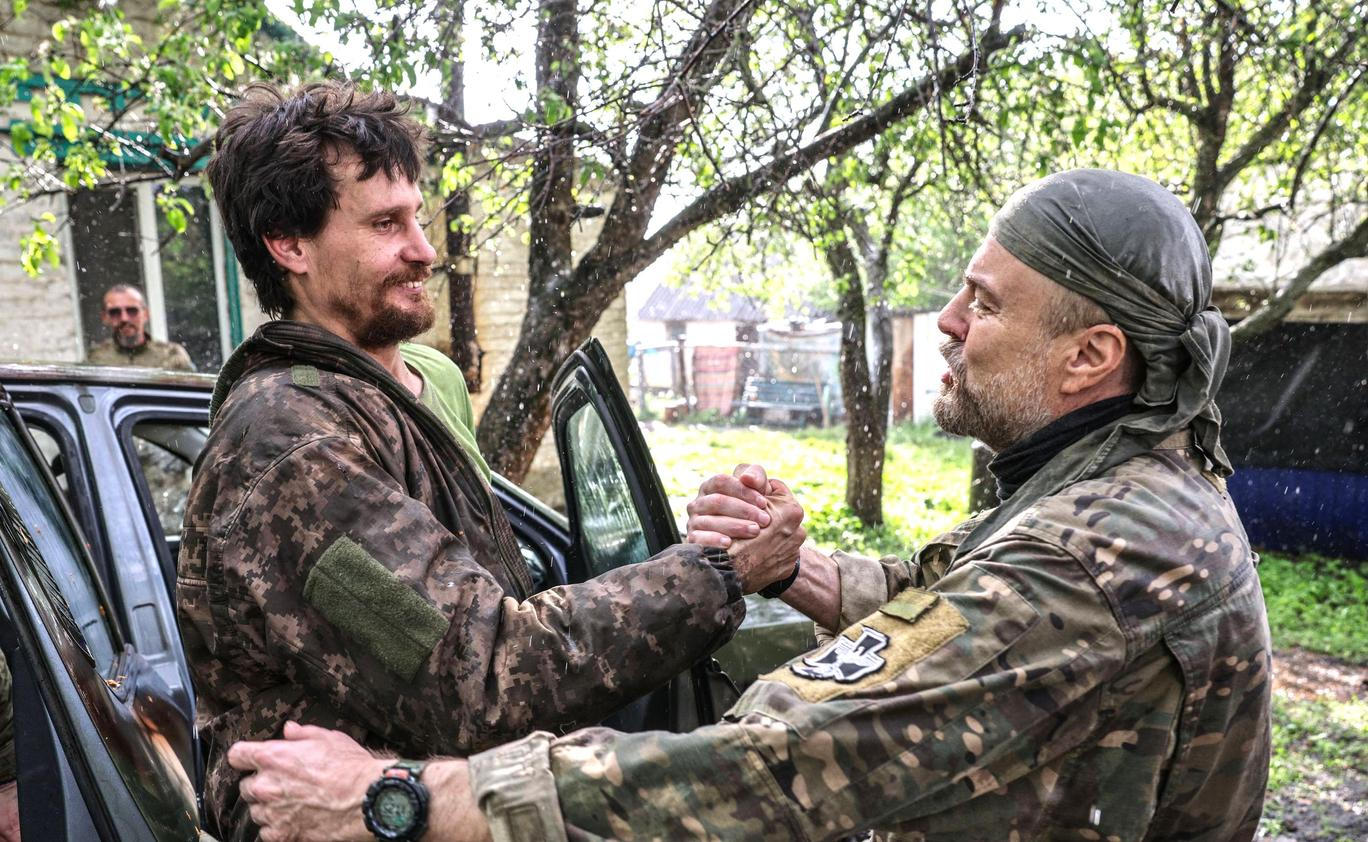 Ukrainian servicemen return from positions near the frontline in Kharkiv region