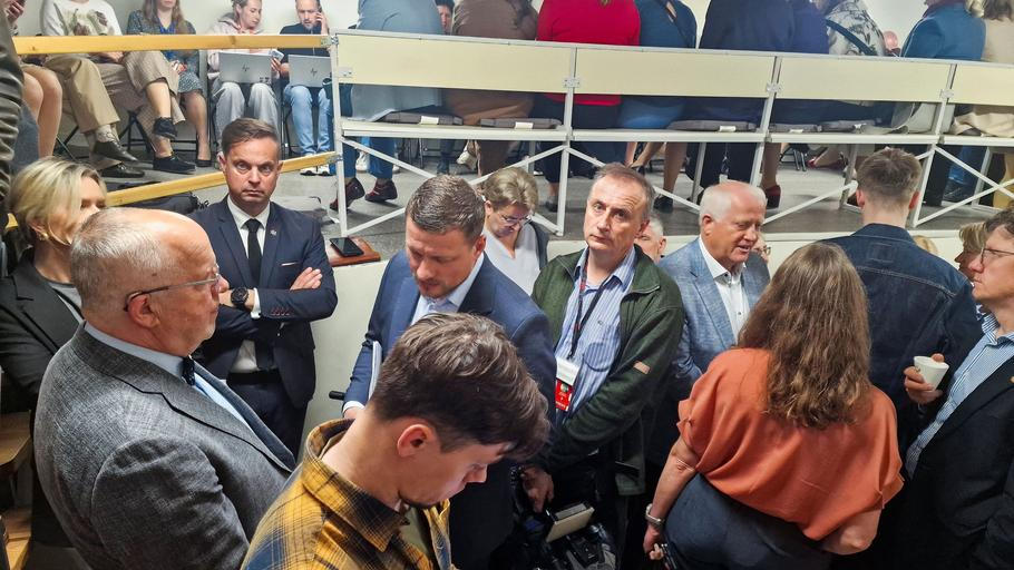People gather inside a shelter at the Lithuanian parliament after an 'air danger' warning, in Vilnius