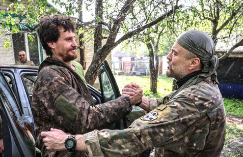 Ukrainian servicemen return from positions near the frontline in Kharkiv region