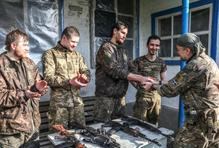 Ukrainian servicemen return from positions near the frontline in Kharkiv region
