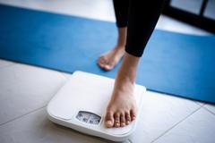 Lose,Weight.,Fat,Diet,And,Scale,Feet,Standing,On,Electronic