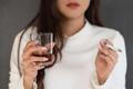 Unhealthy,Asian,Woman,Smoking,Hand,And,Drinking,A,Glass,Of