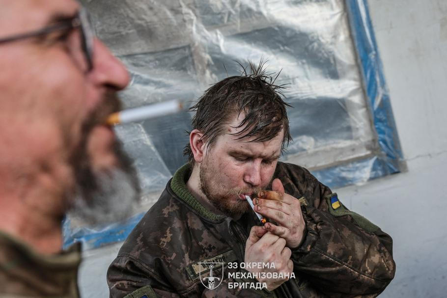 Ukrainian servicemen return from positions near the frontline in Kharkiv region
