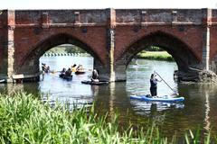 Paddle boarders on the River Great Ouse as temperatures climb over the bank holiday weekend during a heatwave, in Great Barford