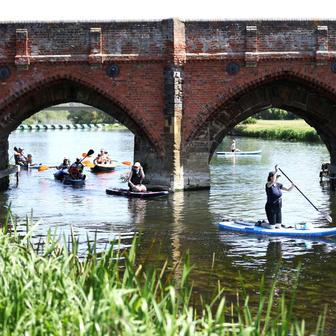Paddle boarders on the River Great Ouse as temperatures climb over the bank holiday weekend during a heatwave, in Great Barford