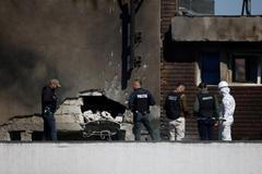 Law enforcement work on the site of an explosion at a residential block of flats following a drone hit in Galati