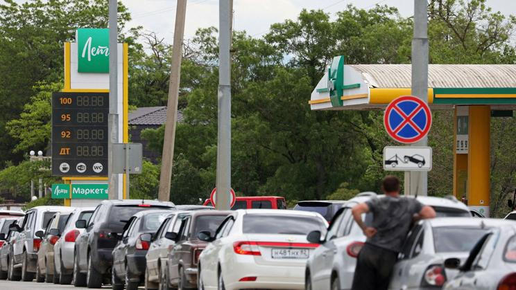 Cars queue for fuel at a gas station in Saki