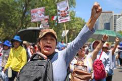 Teachers from Mexico's CNTE union march for higher wages, in Mexico City