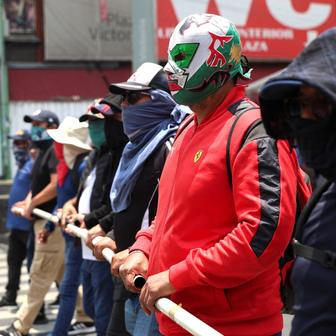 Teachers from Mexico's CNTE union march for higher wages, in Mexico City