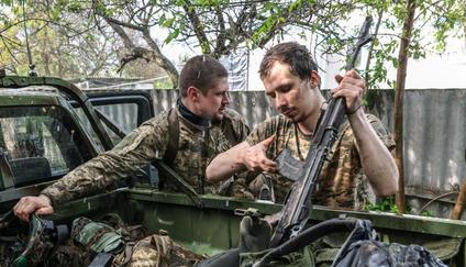 Ukrainian servicemen return from positions near the frontline in Kharkiv region