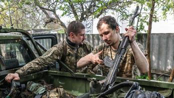 Ukrainian servicemen return from positions near the frontline in Kharkiv region