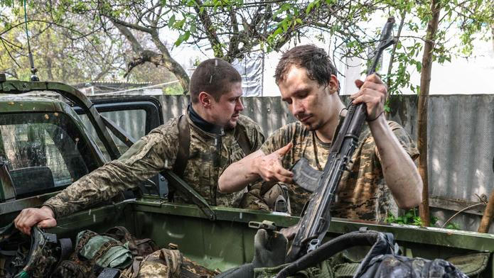 Ukrainian servicemen return from positions near the frontline in Kharkiv region