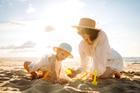 Young,Mother,And,Her,Daughter,Are,Having,Fun,,Building,Sand