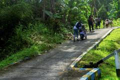 People walk as they evacuate to the highlands after Indonesia’s geophysics agency issued tsunami warning in Tahuna