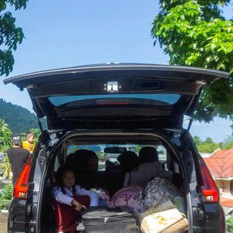 A girl sits in the car as she evacuates after Indonesia’s geophysics agency issued a tsunami warning in Tahuna