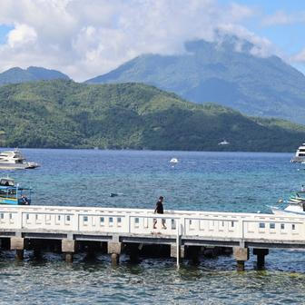 A man walks on a bridge after the Meteorology, Climatology, and Geophysical agency issued a tsunami warning in Ternate