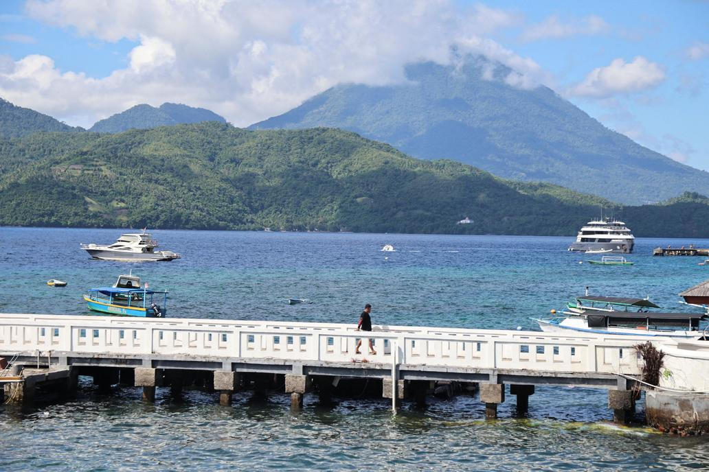 A man walks on a bridge after the Meteorology, Climatology, and Geophysical agency issued a tsunami warning in Ternate