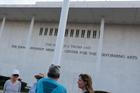 People gather to see if workers remove U.S. President Donald Trump's name from the facade of the John F. Kennedy Memorial Center for the Performing Arts, in Washington, D.C.
