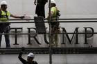 Lettering referencing U.S. President Donald Trump is removed from the facade of the John F. Kennedy Center for the Performing Arts, in Washington