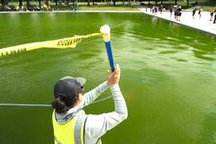 National Park Service workers clean algae from the Lincoln Memorial Reflecting Pool following the completion of recent renovations