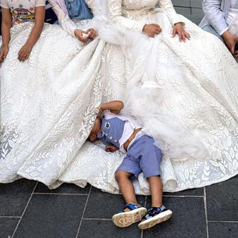 Lebanese groom Hassan Jawad, 22, bride Zainab Khawaja, 20, pose in wedding attire for photos in downtown Beirut
