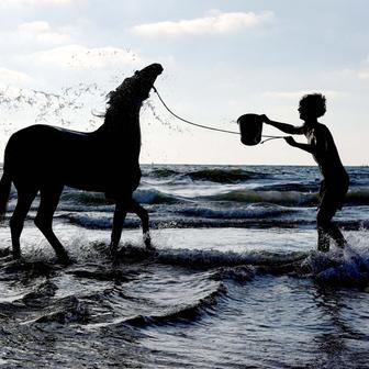 Palestinians gather along the shore of the Mediterranean Sea in Gaza City
