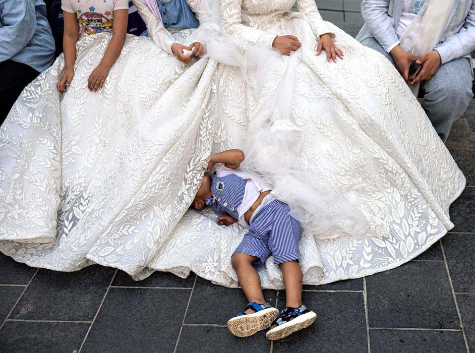Lebanese groom Hassan Jawad, 22, bride Zainab Khawaja, 20, pose in wedding attire for photos in downtown Beirut