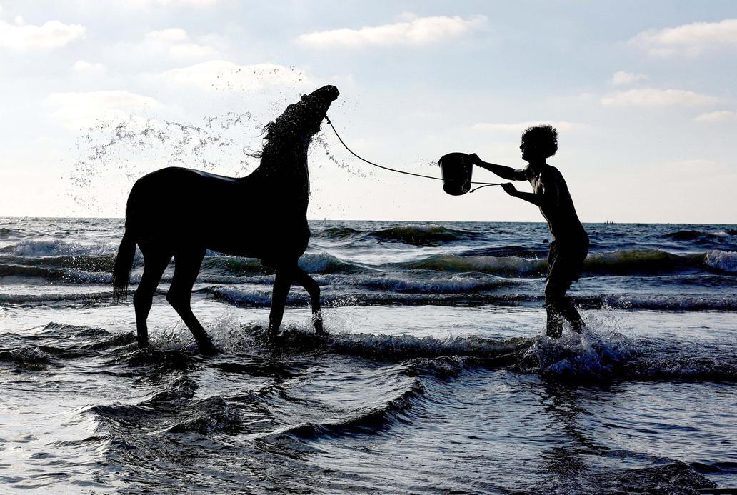 Palestinians gather along the shore of the Mediterranean Sea in Gaza City