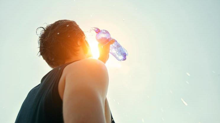 Man,Pouring,Water,From,Plastic,Bottle,On,His,Head,In