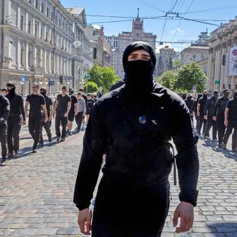 Protesters march denouncing an LGBT+ event in Kyiv