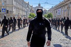 Protesters march denouncing an LGBT+ event in Kyiv