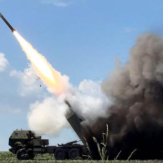 Ukrainian servicemen fire a High Mobility Artillery Rocket System (HIMARS) towards Russian troops near the frontline in Donetsk region