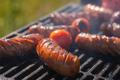 Hot,Grilled,Sausages,On,Barbecue,Grill,With,Smoke,
