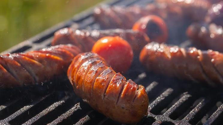 Hot,Grilled,Sausages,On,Barbecue,Grill,With,Smoke,