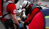 Medical workers evacuate an elderly woman following overnight Russian missile and drone strikes, in Kyiv