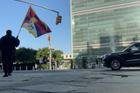 A man identified by Voice of Tibet, a media outlet of exiled Tibetans, as Tibetan activist Lobga Rangzen, walks carrying a Tibetan flag near the United Nations headquarters, before setting himself on fire, in New York