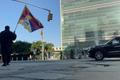 A man identified by Voice of Tibet, a media outlet of exiled Tibetans, as Tibetan activist Lobga Rangzen, walks carrying a Tibetan flag near the United Nations headquarters, before setting himself on fire, in New York