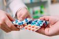Close,Up,Of,A,Girl,Hands,Buying,Pills,In,A