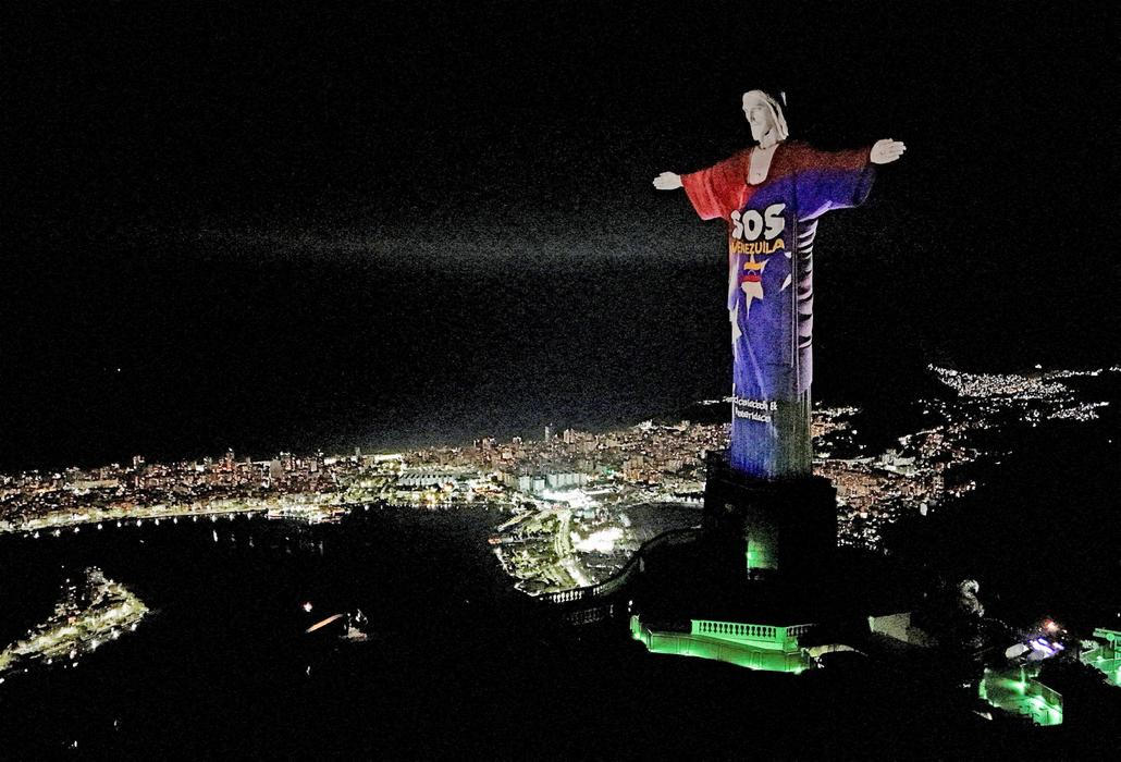 Images are projected on Christ the Redeemer statue in tribute to victims of earthquakes that struck Venezuela on June 24, in Rio de Janeiro