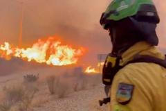 An emergency worker looks on during a wildfire in Almeria