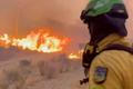 An emergency worker looks on during a wildfire in Almeria