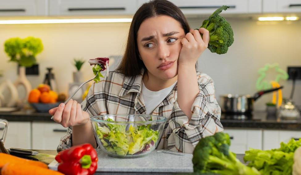 Young,Woman,Eats,Vegetable,Salad,And,Looks,Drained,After,Strict