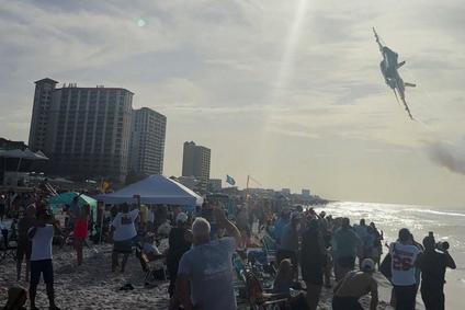 A Navy Blue Angels jet flies low over the crowd on Pensacola Beach