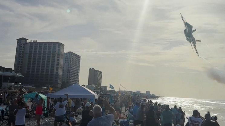 A Navy Blue Angels jet flies low over the crowd on Pensacola Beach