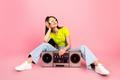 Young,Woman,Lounges,On,A,Pink,Studio,Backdrop,With,A