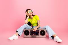 Young,Woman,Lounges,On,A,Pink,Studio,Backdrop,With,A