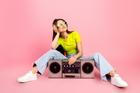 Young,Woman,Lounges,On,A,Pink,Studio,Backdrop,With,A