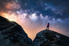 Glowing,Milky,Way,And,Woman,On,Mountain,Peak,At,Starry
